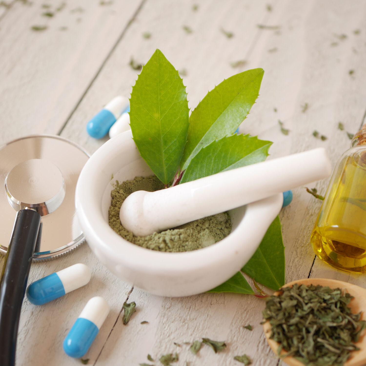 alternative medicine herbal treatment concept. herd with mortar or wooden table top view. capsule and solution medicine.