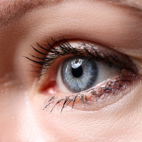 Beautiful blue female eye looking somewhere into distance closeup